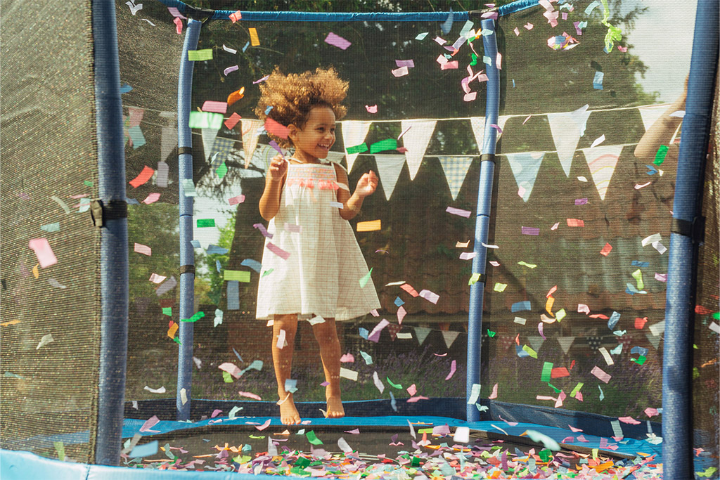 child playing on junior plum trampoline with confetti