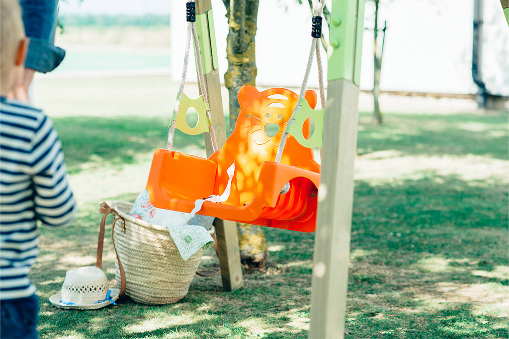 close up of wooden grow baby swing