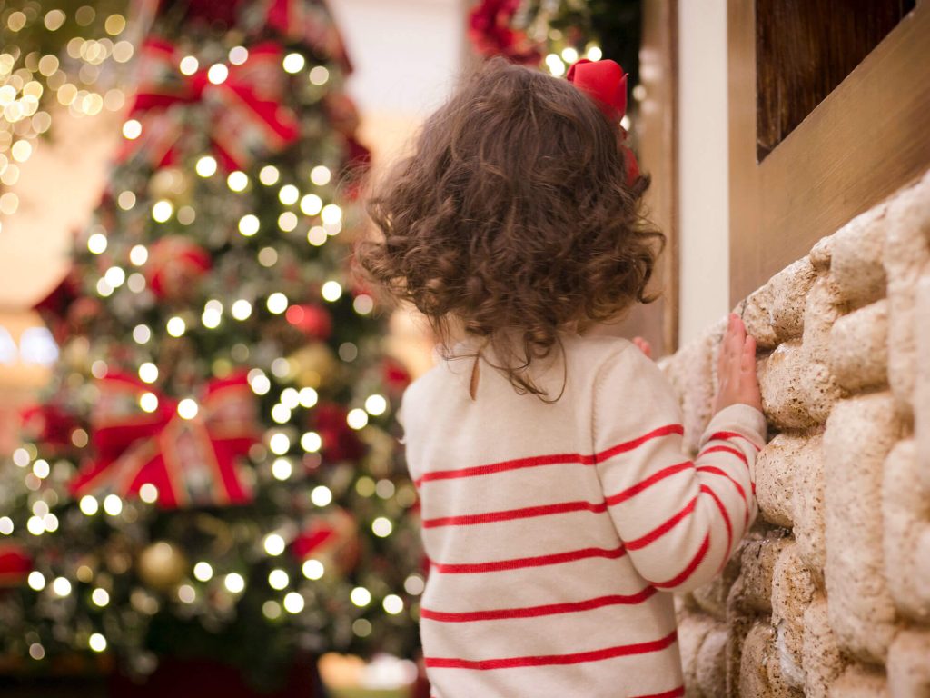 child looking at christmas tree
